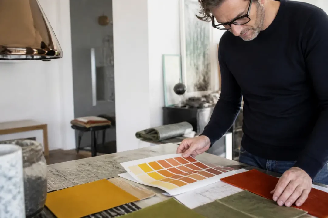 Homme consultant des échantillons de couleurs, travail de décorateurs intérieurs en cours